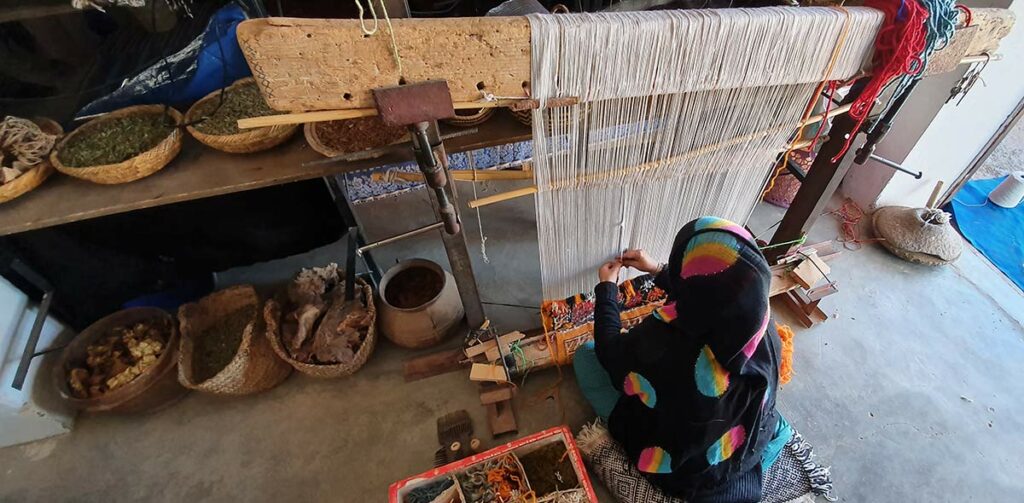 Berber craftswoman at her weaving loom in Taznenakhte